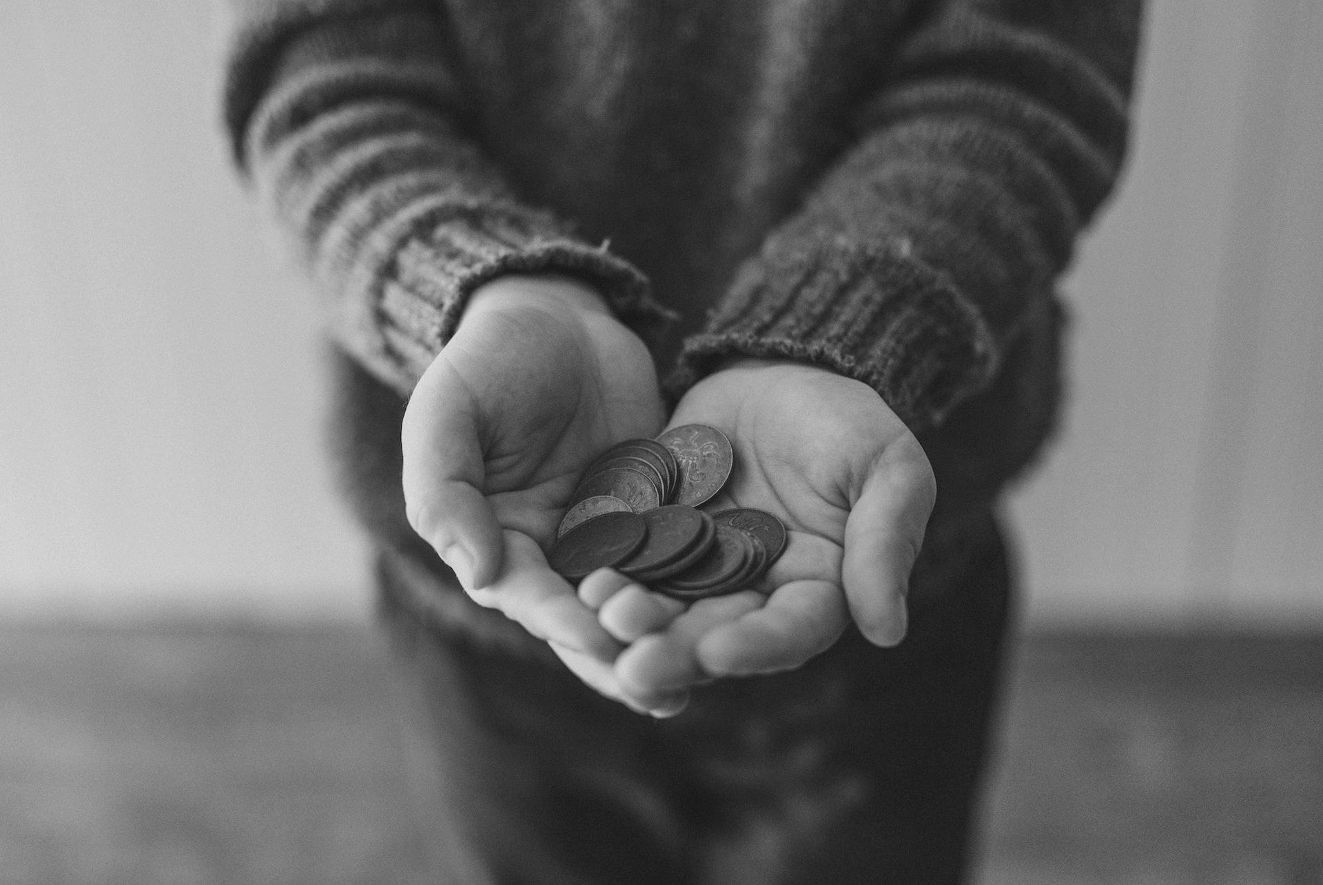 copper-colored coins on in person's hands